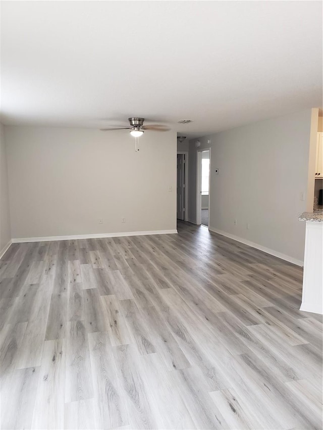 unfurnished living room with light hardwood / wood-style floors and ceiling fan