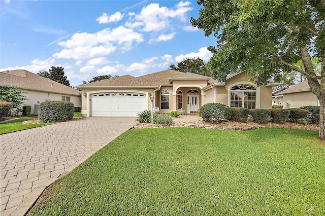 view of front of property featuring a front lawn and a garage