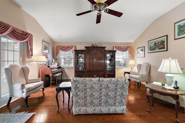 living room with lofted ceiling, a healthy amount of sunlight, and hardwood / wood-style flooring