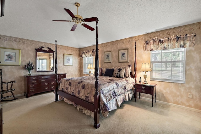 bedroom featuring a textured ceiling, ceiling fan, light colored carpet, and vaulted ceiling