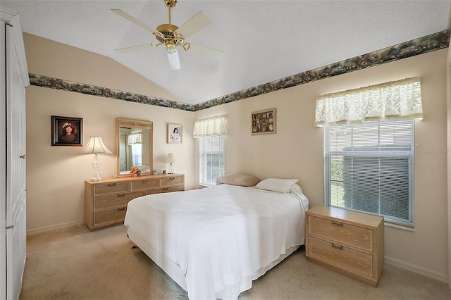 carpeted bedroom featuring vaulted ceiling and ceiling fan