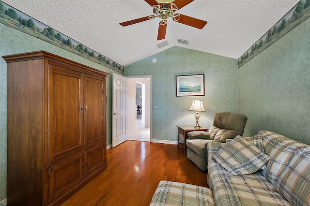 sitting room featuring ceiling fan, a textured ceiling, wood-type flooring, and vaulted ceiling