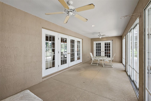 unfurnished sunroom featuring french doors and ceiling fan