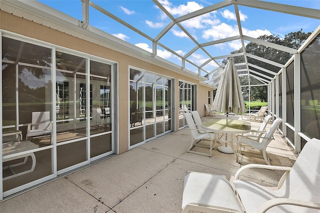 unfurnished sunroom featuring vaulted ceiling