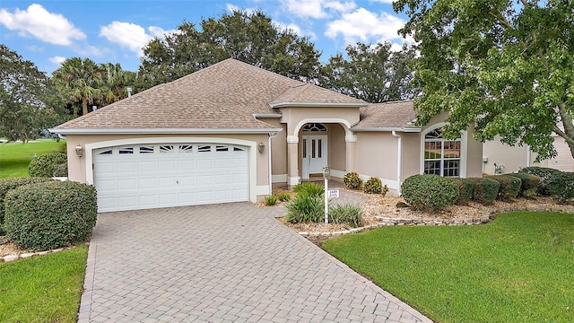 view of front of house featuring a front yard and a garage