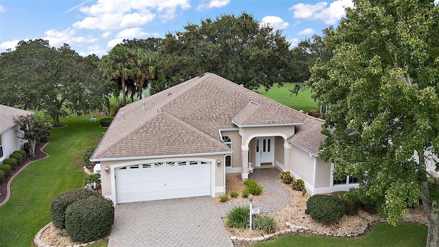 view of front facade with a front lawn and a garage