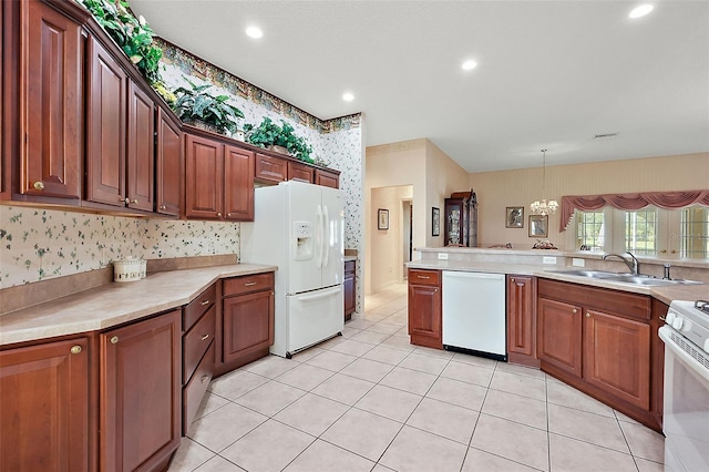 kitchen featuring sink, light tile patterned flooring, pendant lighting, an inviting chandelier, and white appliances