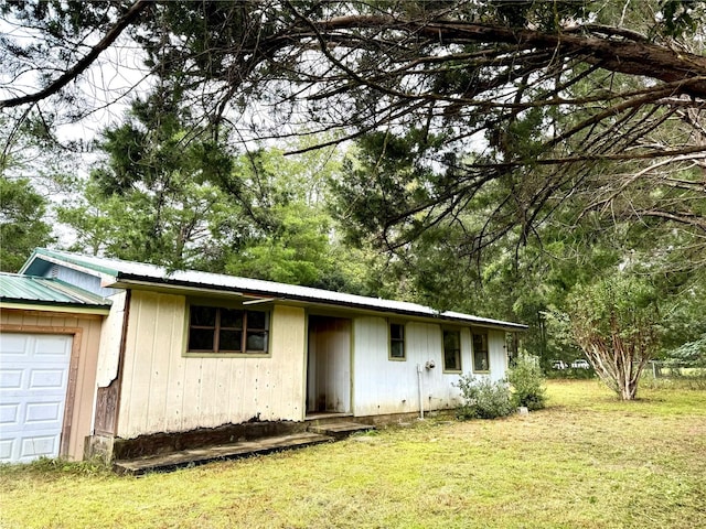 exterior space with a yard and a garage