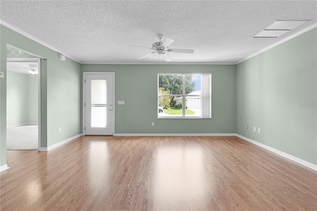 spare room featuring light wood-type flooring, crown molding, ceiling fan, and a textured ceiling