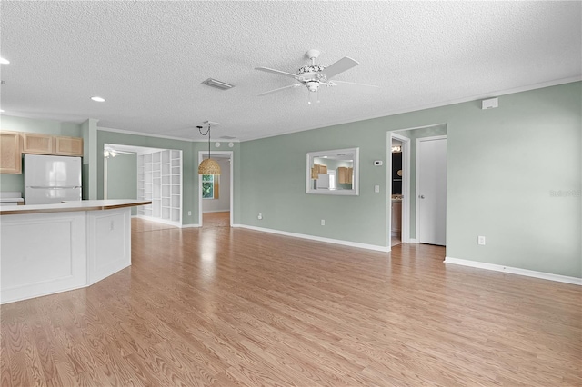 unfurnished living room featuring ceiling fan, light wood-type flooring, and a textured ceiling