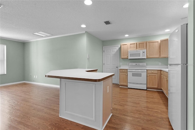 kitchen with white appliances, light hardwood / wood-style flooring, light brown cabinetry, and a textured ceiling