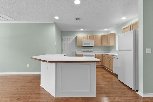 kitchen featuring light wood-type flooring, white appliances, light brown cabinets, and a textured ceiling