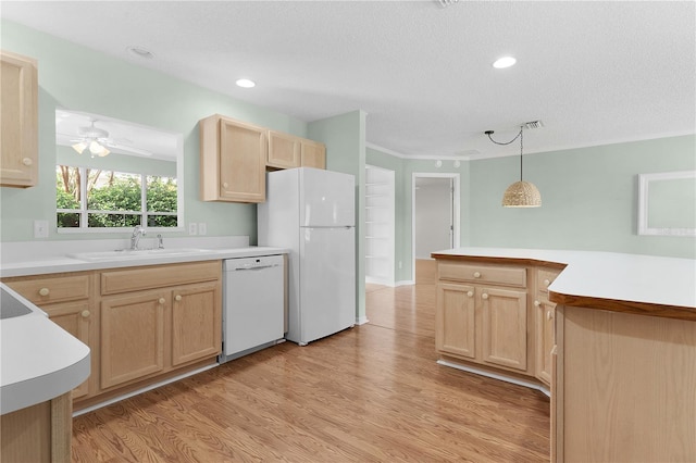 kitchen with pendant lighting, white appliances, light hardwood / wood-style flooring, light brown cabinets, and a textured ceiling