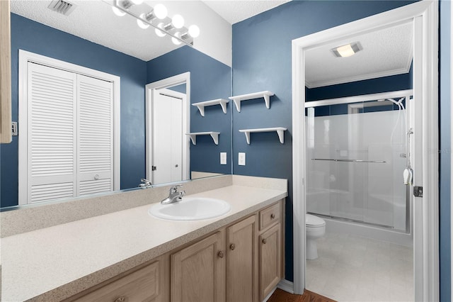 bathroom with vanity, a textured ceiling, toilet, and an enclosed shower