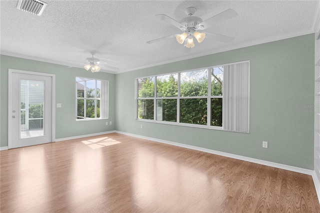 spare room with ceiling fan, crown molding, light wood-type flooring, and a textured ceiling