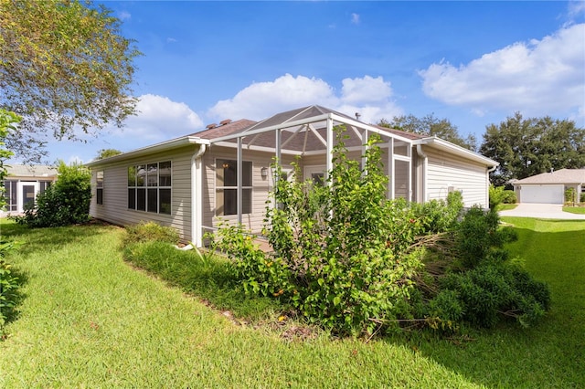 view of home's exterior featuring a lanai and a yard