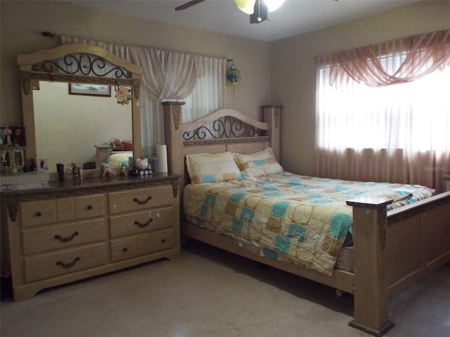 bedroom with ceiling fan and light colored carpet