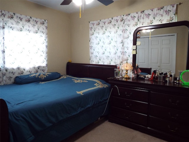 bedroom featuring a closet, ceiling fan, and light colored carpet