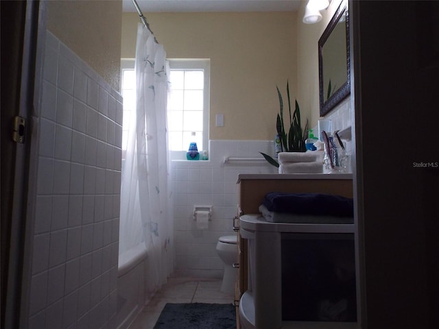 full bathroom with toilet, tile walls, vanity, shower / tub combo with curtain, and tile patterned flooring