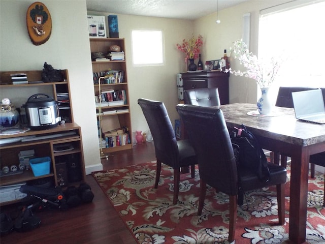 dining room with a textured ceiling and hardwood / wood-style flooring