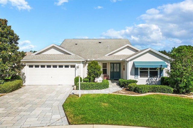 ranch-style home with a front lawn and a garage