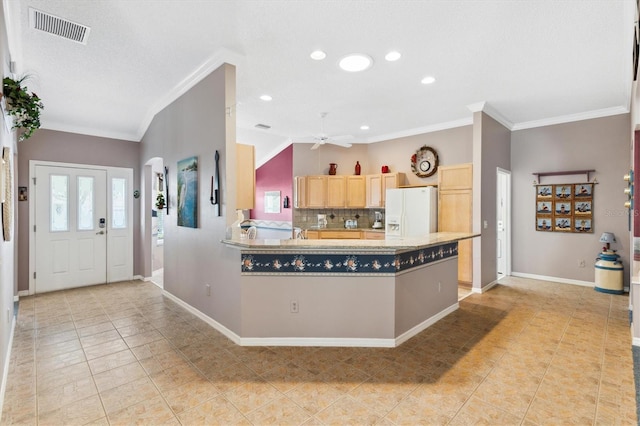 kitchen with light brown cabinetry, crown molding, white refrigerator with ice dispenser, and ceiling fan