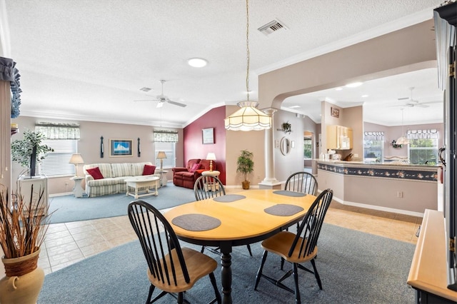 dining area with ceiling fan, crown molding, vaulted ceiling, and tile patterned flooring