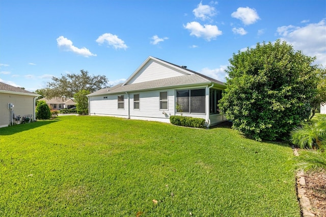 rear view of property featuring a yard