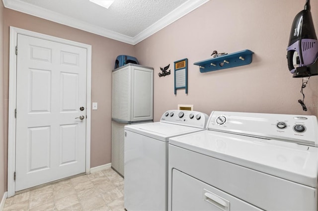 laundry area with ornamental molding, washer and dryer, and a textured ceiling