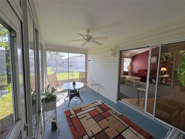 unfurnished sunroom with lofted ceiling and ceiling fan