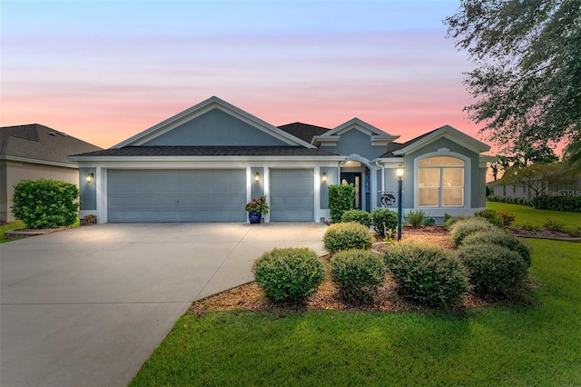 ranch-style home with a yard and a garage