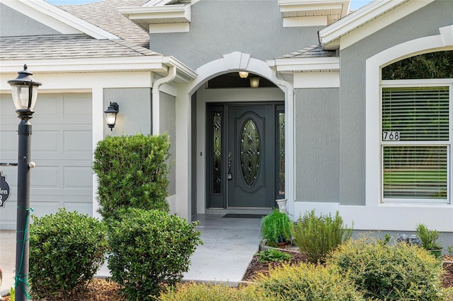 view of exterior entry featuring a garage