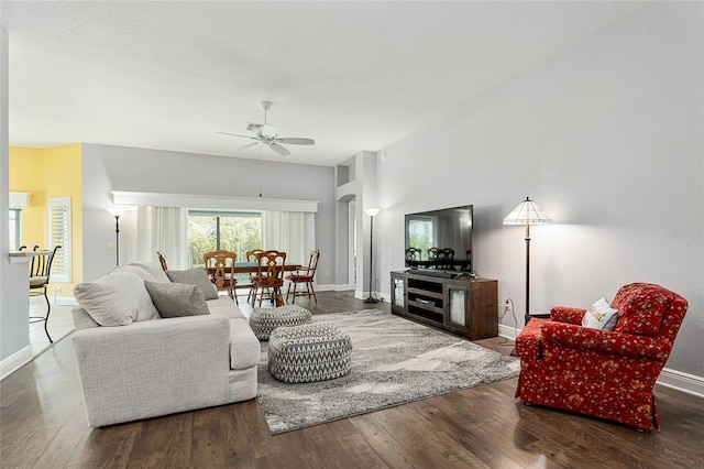 living room featuring dark hardwood / wood-style floors and ceiling fan