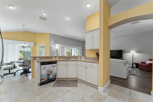 kitchen with dishwasher, white cabinets, light hardwood / wood-style flooring, and a wealth of natural light