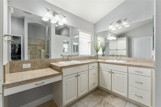 bathroom with lofted ceiling, a shower with shower door, and vanity