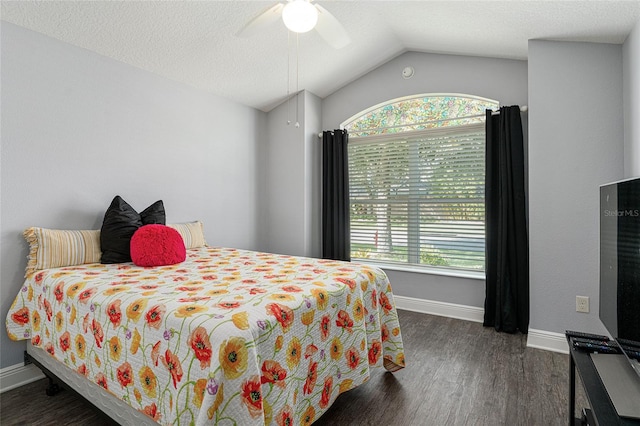 bedroom featuring lofted ceiling, dark hardwood / wood-style floors, a textured ceiling, and ceiling fan