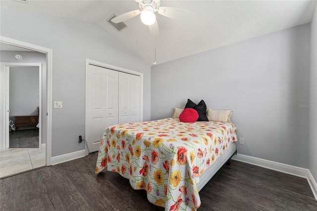 bedroom with lofted ceiling, ceiling fan, a closet, and dark hardwood / wood-style floors