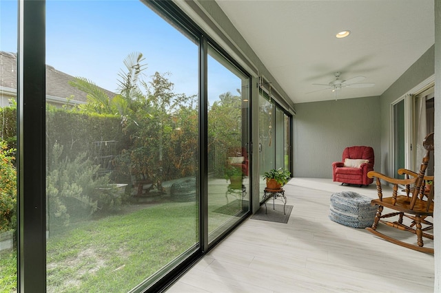 sunroom featuring ceiling fan