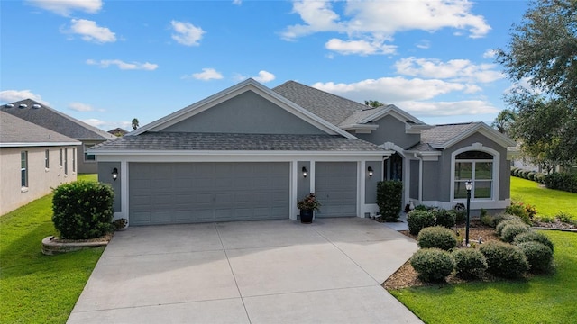 single story home featuring a garage and a front lawn