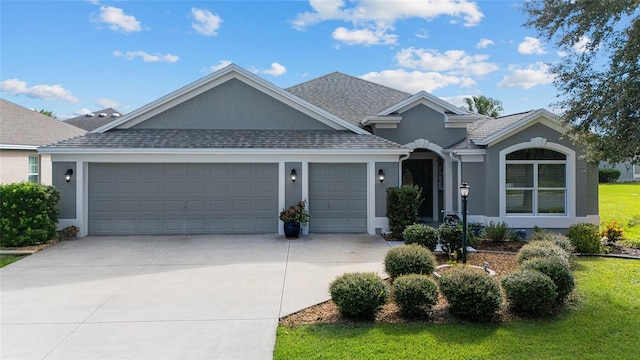 view of front facade featuring a garage and a front lawn