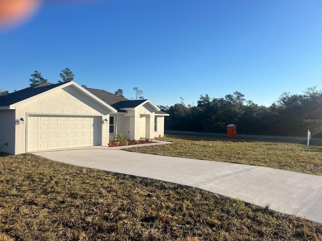 single story home with a garage and a front yard