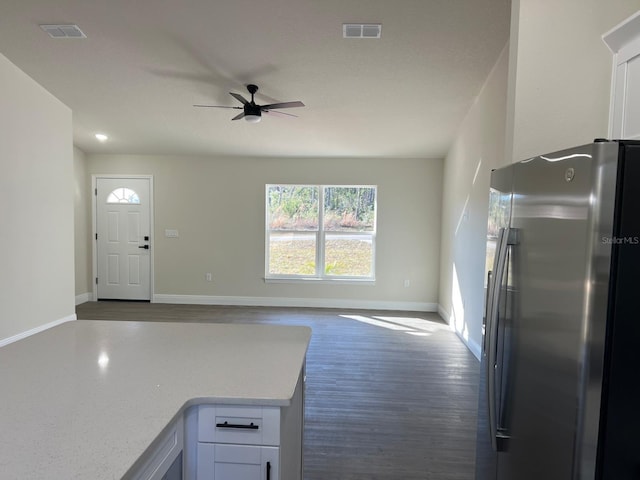 kitchen with white cabinets, stainless steel fridge, dark hardwood / wood-style floors, and ceiling fan