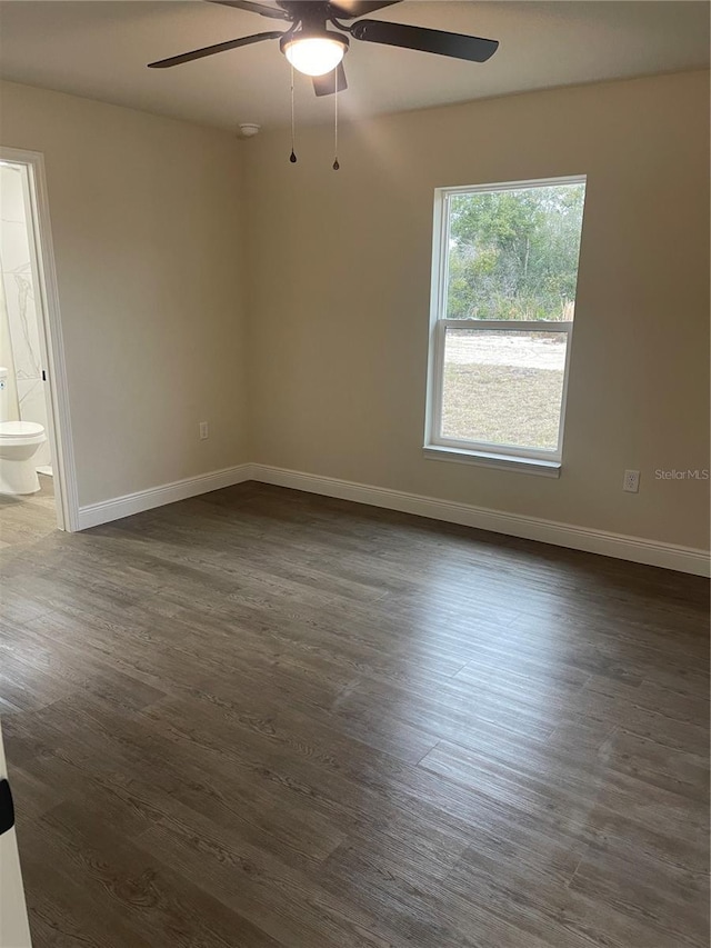 unfurnished room with ceiling fan and dark wood-type flooring