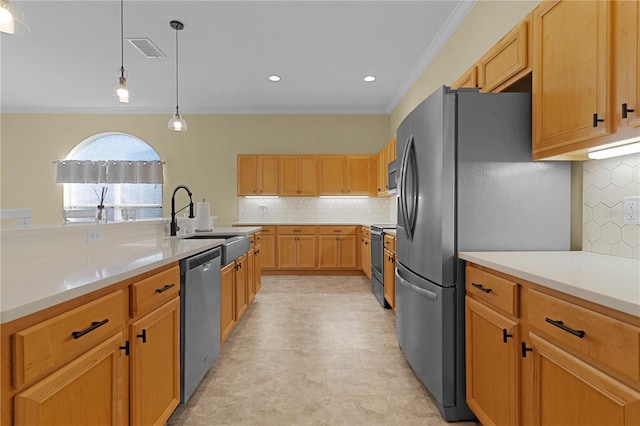 kitchen featuring backsplash, sink, crown molding, hanging light fixtures, and appliances with stainless steel finishes