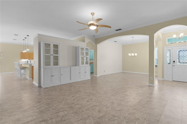 unfurnished living room featuring ornamental molding, ceiling fan with notable chandelier, and sink