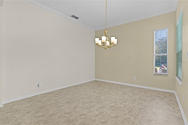 spare room with crown molding and a chandelier