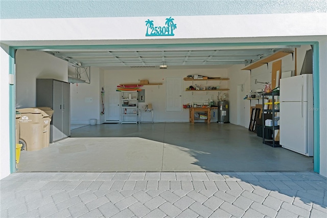 garage featuring white fridge and water heater