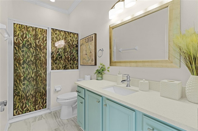 bathroom with toilet, vanity, and ornamental molding