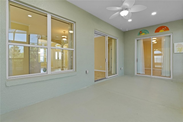 spare room with ceiling fan and concrete flooring