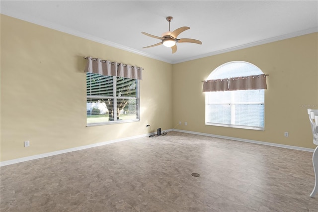 empty room featuring ceiling fan and ornamental molding